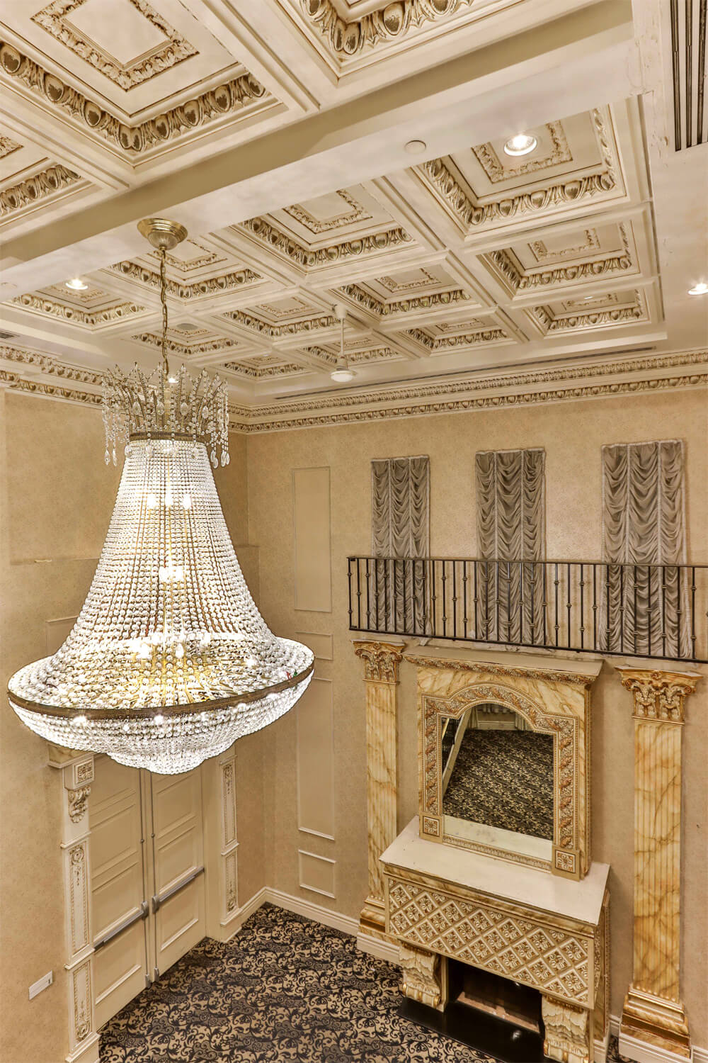 The Versailles Venue's chandelier and fireplace