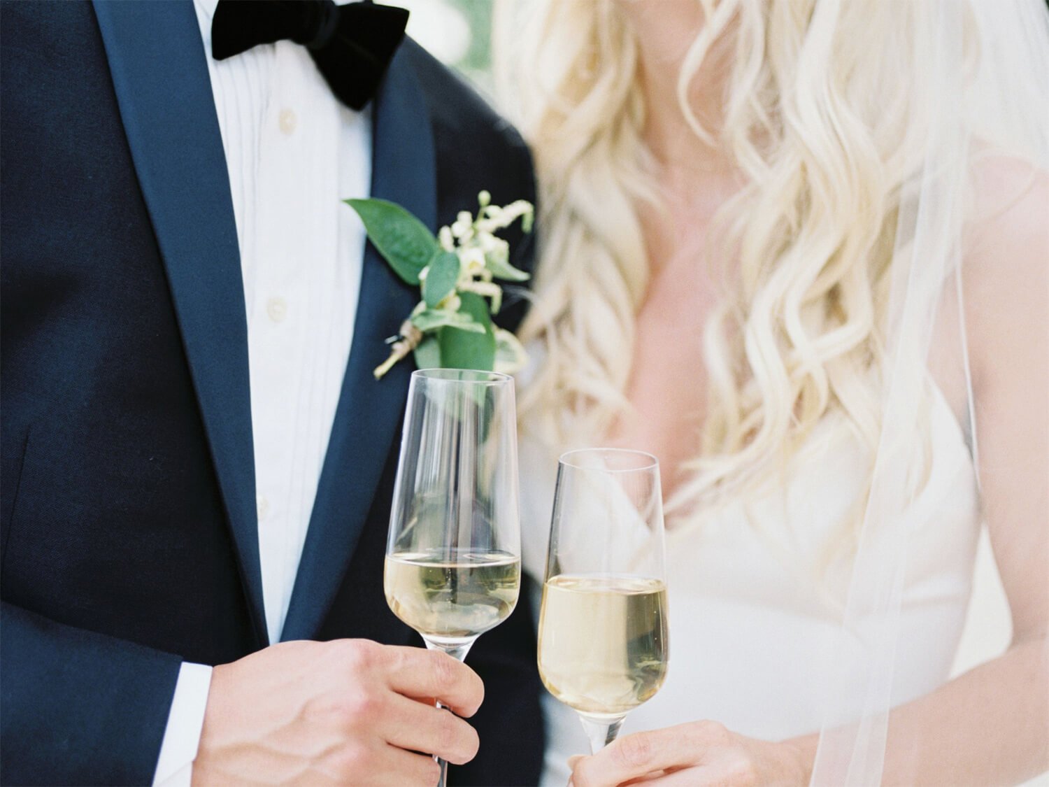 Bride and Groom holding wedding champagne glasses